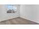 Spacious bedroom with carpet and window overlooking the community at 40080 W Venture Rd, Maricopa, AZ 85138