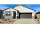 New single-story home with a two-car garage and desert landscaping at 40080 W Venture Rd, Maricopa, AZ 85138