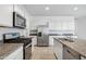 Modern kitchen with stainless steel appliances and granite countertops at 40080 W Venture Rd, Maricopa, AZ 85138