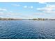 Calm lakefront with homes in the background at 40080 W Venture Rd, Maricopa, AZ 85138