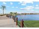 Scenic walkway along a lake with a waterfall feature at 40080 W Venture Rd, Maricopa, AZ 85138