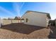 Backyard view of house exterior, gravel landscaping, and block wall at 738 W Jardin Dr, Casa Grande, AZ 85122