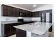 Spacious kitchen with dark cabinets and granite countertops at 738 W Jardin Dr, Casa Grande, AZ 85122