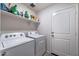 Laundry room with Whirlpool washer and dryer and shelving at 738 W Jardin Dr, Casa Grande, AZ 85122