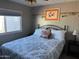 Spacious bedroom with a queen-size bed and artwork at 8600 E Broadway Rd # 9, Mesa, AZ 85208