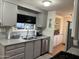 Gray kitchen with double sink, stainless steel appliances, and breakfast bar at 8600 E Broadway Rd # 9, Mesa, AZ 85208