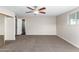 Spacious bedroom with ceiling fan and access to bathroom at 1231 W La Jolla Dr, Tempe, AZ 85282