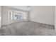 Large bedroom with gray carpeting and a bay window offering natural light at 14825 W Devlin Dr, Goodyear, AZ 85395