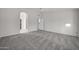 Large bedroom with gray carpeting and access to bathroom at 14825 W Devlin Dr, Goodyear, AZ 85395