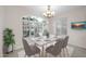 Charming dining room with large window, seating for six, and decorative chandelier at 14825 W Devlin Dr, Goodyear, AZ 85395