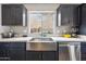 Kitchen features a farmhouse sink and stainless steel dishwasher at 14850 W Laurel Ln, Surprise, AZ 85379