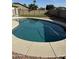 Inviting kidney-shaped pool in a fenced backyard at 15239 W Gelding Dr, Surprise, AZ 85379