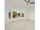 Spacious bedroom with large windows and ceiling fan at 15744 W Clear Canyon Dr, Surprise, AZ 85374