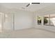 Well-lit bedroom with backyard view and ceiling fan at 15744 W Clear Canyon Dr, Surprise, AZ 85374