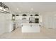 Modern kitchen with white cabinets and large island at 15744 W Clear Canyon Dr, Surprise, AZ 85374
