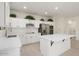 Bright kitchen with island, stainless steel appliances, and white cabinets at 15744 W Clear Canyon Dr, Surprise, AZ 85374