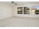 Bright living room with large windows and ceiling fan at 15744 W Clear Canyon Dr, Surprise, AZ 85374