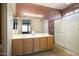 Double vanity bathroom with a large mirror and walk-in shower at 17346 W Alder Ln, Surprise, AZ 85387