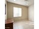 Bright bedroom with tile floors and a large window at 17346 W Alder Ln, Surprise, AZ 85387