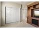 Bedroom with double door closet and built-in entertainment center at 17346 W Alder Ln, Surprise, AZ 85387