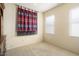 Well-lit bedroom with neutral decor and window blinds at 17346 W Alder Ln, Surprise, AZ 85387