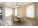 Bright dining room with large table and neutral colored chairs at 17346 W Alder Ln, Surprise, AZ 85387