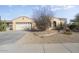 Single-story home with a two-car garage and desert landscaping at 17346 W Alder Ln, Surprise, AZ 85387