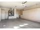 Garage with ample storage cabinets and flooring at 17346 W Alder Ln, Surprise, AZ 85387