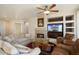 Spacious living room featuring a fireplace and built-in entertainment center at 17346 W Alder Ln, Surprise, AZ 85387