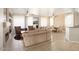Spacious living room with a fireplace and large windows at 17346 W Alder Ln, Surprise, AZ 85387