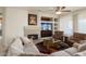 Living room with fireplace, built-in shelving, and comfy seating at 17346 W Alder Ln, Surprise, AZ 85387
