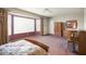 Main bedroom with a large window, walk-in closet, and ensuite bathroom at 17346 W Alder Ln, Surprise, AZ 85387