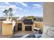 Outdoor kitchen with grill and built-in cabinets at 17346 W Alder Ln, Surprise, AZ 85387