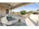 Covered patio with seating area and desert landscaping at 17346 W Alder Ln, Surprise, AZ 85387