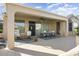 Spacious covered patio with seating and ceiling fan at 17346 W Alder Ln, Surprise, AZ 85387