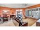 Living and dining area with leather furniture and large windows at 19807 N White Rock Dr, Sun City West, AZ 85375