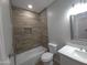 Updated bathroom with white vanity, bathtub, and wood-like tile at 26165 W Desert Crest St, Casa Grande, AZ 85193