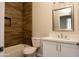 Clean bathroom with white vanity, bathtub, and wood-look tile at 26165 W Desert Crest St, Casa Grande, AZ 85193