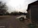 Gravel backyard with trees and a concrete patio at 30138 W Roosevelt St, Buckeye, AZ 85396