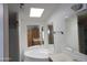 Bathroom with double sinks, large tub, and skylight at 30138 W Roosevelt St, Buckeye, AZ 85396