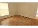 Bedroom with wood-look floors and large window at 30138 W Roosevelt St, Buckeye, AZ 85396