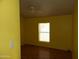 Bedroom with wood-look floors, window, and ceiling fan at 30138 W Roosevelt St, Buckeye, AZ 85396