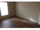 Simple bedroom with wood-look flooring and window at 30138 W Roosevelt St, Buckeye, AZ 85396
