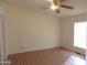 Bright bedroom with laminate flooring and ceiling fan at 30138 W Roosevelt St, Buckeye, AZ 85396