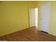 Spacious bedroom with wood-look floors and access to hallway at 30138 W Roosevelt St, Buckeye, AZ 85396
