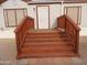 Mobile home entrance with wood stairs and railing at 30138 W Roosevelt St, Buckeye, AZ 85396
