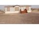 Tan mobile home with wood deck and stairs at 30138 W Roosevelt St, Buckeye, AZ 85396