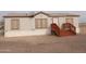 Tan mobile home with wood deck and stairs at 30138 W Roosevelt St, Buckeye, AZ 85396