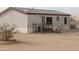 Rear view of mobile home with fenced area at 30138 W Roosevelt St, Buckeye, AZ 85396