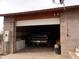 Exterior view of garage with open door and truck inside at 30138 W Roosevelt St, Buckeye, AZ 85396